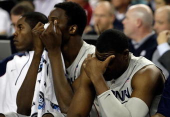 DETROIT - APRIL 04:  (L-R) Hasheem Thabeet #34 and Jeff Adrien #4 of the Connecticut Huskies covers his face in the second half against the Michigan State Spartans during the National Semifinal game of the NCAA Division I Men's Basketball Championship at Ford Field on April 4, 2009 in Detroit, Michigan. The Spartans defeated the Huskies 82-73.  (Photo by Andy Lyons/Getty Images)