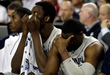DETROIT - APRIL 04:  (L-R) Hasheem Thabeet #34 and Jeff Adrien #4 of the Connecticut Huskies covers his face in the second half against the Michigan State Spartans during the National Semifinal game of the NCAA Division I Men's Basketball Championship at Ford Field on April 4, 2009 in Detroit, Michigan. The Spartans defeated the Huskies 82-73.  (Photo by Andy Lyons/Getty Images)
