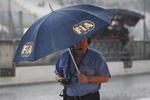 MONZA, ITALY - SEPTEMBER 12:  F.I.A. official shelters from the rain during practice for the Italian Formula One Grand Prix at the Autodromo Nazionale di Monza on September 12, 2008 in Monza, Italy.  (Photo by Mark Thompson/Getty Images)