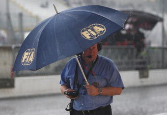 MONZA, ITALY - SEPTEMBER 12:  F.I.A. official shelters from the rain during practice for the Italian Formula One Grand Prix at the Autodromo Nazionale di Monza on September 12, 2008 in Monza, Italy.  (Photo by Mark Thompson/Getty Images)