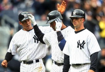 NEW YORK - APRIL 04: Derek Jeter #2 of the New York Yankees celebrates hitting his three run home run with teammates Cody Ransom #12 and  Brett Gardner #11 against the Chicago Cubs during their game on April 4, 2009 at Yankee Stadium in the Bronx borough of New York City.  (Photo by Nick Laham/Getty Images)