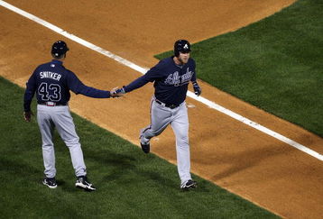 PHILADELPHIA - APRIL 05:  Brian McCann #16 of the Atlanta Braves is congratulated by third base coach Brian Snitker after McCann hit a two-run home run in the first inning of their game against the Philadelphia Phillies on April 5, 2009 at Citizens Bank Park in Philadelphia, Pennsylvania. Today's game is the opening of the 2009 major league baseball season.  (Photo by Ezra Shaw/Getty Images)