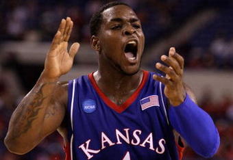 INDIANAPOLIS - MARCH 27:  Sherron Collins #4 of the Kansas Jayhawks reacts in the first half against the Michigan State Spartans during the third round of the NCAA Division I Men's Basketball Tournament at the Lucas Oil Stadium on March 27, 2009 in Indianapolis, Indiana.  (Photo by Andy Lyons/Getty Images)