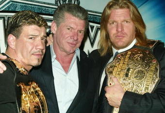 NEW YORK - MARCH 11:  (L-R) Wrestler Eddie Guerrero, WWE Chairman Vince McMahon and Wrestler Triple H attend a press conference to promote Wrestlemania XX at Planet Hollywood March 11, 2004 in New York City.  (Photo by Peter Kramer/Getty Images)