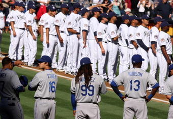 SAN DIEGO - APRIL 6:    The Los Angeles Dodgers and the San Diego Padres stand on the baselines during openng day pregame ceremonies on April 6, 2009 at Petco Park in San Diego, California.   (Photo by Stephen Dunn/Getty Images)
