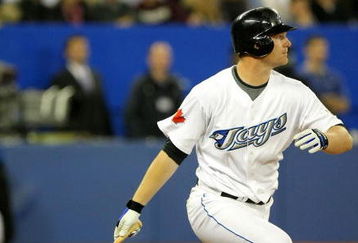 TORONTO - APRIL 6:  Adam Lind #26 of the Toronto Blue Jays hits an opening day Blue Jays record 6th RBI against  the Detroit Tigers in the 8th inning during their MLB game at the Rogers Centre April 6, 2009 in Toronto, Ontario.(Photo By Dave Sandford/Getty Images)