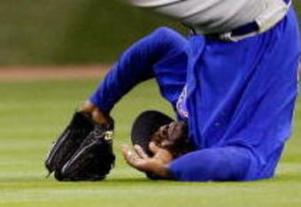 HOUSTON - APRIL 06:  Milton Bradley #21 of the Chicago Cubs flips over after missing a fly ball against the Houston Astros on Opening Day on April 6, 2009 at Minute Maid Park in Houston, Texas.  The Cubs defeated the Astros 4-2.  (Photo by Chris Graythen/Getty Images)