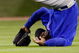 HOUSTON - APRIL 06:  Milton Bradley #21 of the Chicago Cubs flips over after missing a fly ball against the Houston Astros on Opening Day on April 6, 2009 at Minute Maid Park in Houston, Texas.  The Cubs defeated the Astros 4-2.  (Photo by Chris Graythen/Getty Images)