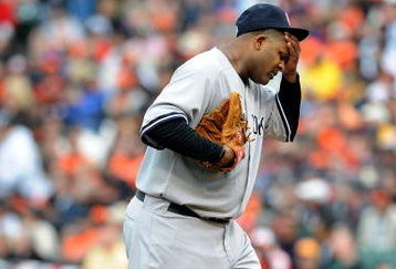 BALTIMORE - APRIL 06:  C.C. Sabathia #52 of the New York Yankees wipes his head after giving up three runs in the third inning against the Baltimore Orioles during opening day on April 6, 2009 at Camden Yards in Baltimore, Maryland.  (Photo by Greg Fiume/Getty Images)