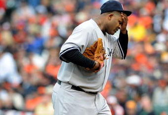 BALTIMORE - APRIL 06:  C.C. Sabathia #52 of the New York Yankees wipes his head after giving up three runs in the third inning against the Baltimore Orioles during opening day on April 6, 2009 at Camden Yards in Baltimore, Maryland.  (Photo by Greg Fiume/Getty Images)