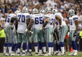 IRVING, TX - DECEMBER 14: Leonard Davis #70, Andre Guride #65 and Cory Procter #71 of the Dallas Cowboys listen in the huddle against the New York Giants at Texas Stadium on December 14, 2008 in Irving, Texas. (Photo by Ronald Martinez/Getty Images)