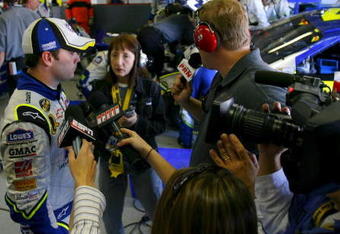 FORT WORTH, TX - APRIL 15:  Jimmie Johnson, driver of the #48 Lowe's Chevrolet, speaks with members of the media after crashing during the NASCAR Nextel Cup Series Samsung 500 at Texas Motor Speedway on April 15, 2007 in Fort Worth, Texas.  (Photo by Rusty Jarrett/Getty Images for NASCAR)