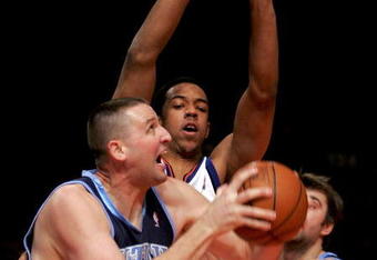 NEW YORK - DECEMBER 23:  Greg Ostertag #00 of the Utah Jazz tries to shoot over Channing Frye #7 of the New York Knicks on December 23, 2005 at Madison Square Garden in New York City. NOTE TO USER: User expressly acknowledges and agrees that, by downloading and or using this photograph, User is consenting to the terms and conditions of the Getty Images License Agreement.  (Photo by Ezra Shaw/Getty Images)