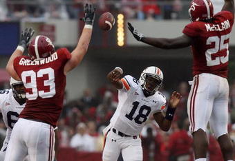 TUSCALOOSA, AL - NOVEMBER 29:  Quarterback Kodi Burns #18 of the Auburn Tigers has a pass tipped by defensive lineman Bobby Greenwood #93 and linebacker Rolando McClain #25 of the Alabama Crimson Tide at Bryant-Denny Stadium on November 29, 2008 in Tuscaloosa, Alabama.  (Photo by Doug Benc/Getty Images)
