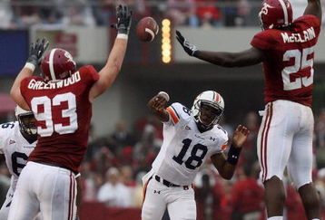 TUSCALOOSA, AL - NOVEMBER 29:  Quarterback Kodi Burns #18 of the Auburn Tigers has a pass tipped by defensive lineman Bobby Greenwood #93 and linebacker Rolando McClain #25 of the Alabama Crimson Tide at Bryant-Denny Stadium on November 29, 2008 in Tuscaloosa, Alabama.  (Photo by Doug Benc/Getty Images)