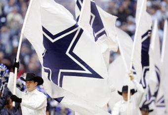 DALLAS - DECEMBER 16: Cheerleaders of the Dallas Cowboys carry flags against the Philadelphia Eagles in the fourth quarter at Texas Stadium December 16, 2007 in Dallas, Texas. The Eagles won 10-6. (Photo by Brian Bahr/Getty Images)