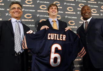 LAKE FOREST, IL - APRIL 3:  Chicago Bears general manager Jerry Angelo, quarterback Jay Cutler and head coach Lovie Smith are all smiles after introducing Cutler as their new quarterback during a press conference on April 3, 2009 at Halas Hall in Lake Forest, Illinois. (Photo by Jim Prisching/Getty Images)