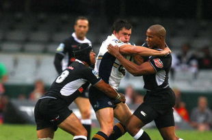 DURBAN, SOUTH AFRICA - MARCH 28:  Adam Ashley-Cooper of the Brumbies is tackled by JP Pietersen (R) and Adrian Jacobs of Sharks during the Super 14 Round 7 match between Sharks and Brumbies at ABSA Stadium on March 28, 2009 in Durban, South Africa. (Photo by Anesh Debiky/Gallo Images/Getty Images)