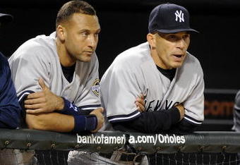 BALTIMORE - APRIL 06:   Derek Jeter #2 and manager Joe Girardi of the New York Yankees watch the game against the Baltimore Orioles during opening day on April 6, 2009 at Camden Yards in Baltimore, Maryland.  (Photo by Greg Fiume/Getty Images)