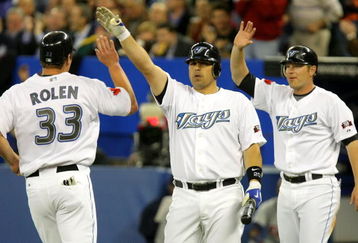 TORONTO - APRIL 6:  Scott Rolen #33 of the Toronto Blue Jays is congratulated by teammates Rod Barajas #20 and Adam Lind #26 after scoring a run  against the Detroit Tigers during their MLB game at the Rogers Centre April 6, 2009 in Toronto, Ontario.(Photo By Dave Sandford/Getty Images)