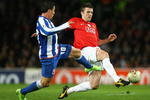 MANCHESTER, UNITED KINGDOM - APRIL 07:  Cristian Rodriguez of FC Porto challenges Michael Carrick of Manchester United during the UEFA Champions League Quarter Final First Leg match between Manchester United and FC Porto at Old Trafford on April 7, 2009 in Manchester, England. (Photo by Alex Livesey/Getty Images)