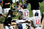 CHICAGO - MAY 20:  Manager Ozzie Guillen #13 of the Chicago White Sox, manager Dusty Baker #12 of the Chicago Cubs and home plate umpire Greg Gibson #53 try to break up a fight involing John Mabry #17 of the Cubs and Brian Anderson #44 of the White Sox on May 20, 2006 at U.S. Cellular Field in Chicago, Illinois.  (Photo by Jonathan Daniel/Getty Images)