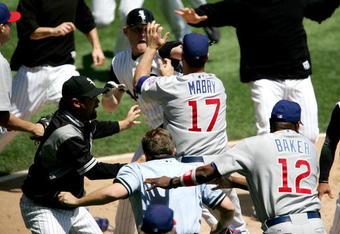 CHICAGO - MAY 20:  Manager Ozzie Guillen #13 of the Chicago White Sox, manager Dusty Baker #12 of the Chicago Cubs and home plate umpire Greg Gibson #53 try to break up a fight involing John Mabry #17 of the Cubs and Brian Anderson #44 of the White Sox on May 20, 2006 at U.S. Cellular Field in Chicago, Illinois.  (Photo by Jonathan Daniel/Getty Images)
