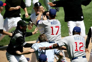 CHICAGO - MAY 20:  Manager Ozzie Guillen #13 of the Chicago White Sox, manager Dusty Baker #12 of the Chicago Cubs and home plate umpire Greg Gibson #53 try to break up a fight involing John Mabry #17 of the Cubs and Brian Anderson #44 of the White Sox on May 20, 2006 at U.S. Cellular Field in Chicago, Illinois.  (Photo by Jonathan Daniel/Getty Images)