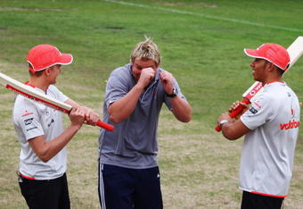 MELBOURNE, AUSTRALIA - MARCH 26:  McLaren Mercedes drivers Heikki Kovalainen (L) of Finland and Lewis Hamilton (R) of Great Britain share a joke with Australian cricket legend Shane Warne (C) following a game of 'backyard' cricket in Central Melbourne's Fawkner Park during previews to the Australian Formula One Grand Prix on March 26, 2009 in Melbourne, Australia.  (Photo by Clive Mason/Getty Images)