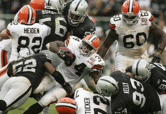 OAKLAND, CA - OCTOBER 01:  Reuben Droughns #34 of the Cleveland Browns is tackled by Kirk Morrison #52 of the Oakland Raiders October 1, 2006 at McAfee Coliseum in Oakland, California.  (Photo by Jonathan Ferrey/Getty Images)