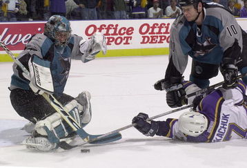 14 Apr 2001:  Goaltender Evgeni Nabokov #35 of the San Jose Sharks stops a shot while Keith Tkachuk #7 of the St.Louis Blues is cross checked by Marcus Ragnarsson #10 of the San Jose Sharks at the Savvis Center in St.Louis, Missouri.The San Jose Sharks beat the St.Louis Blues 1-0. DIGITAL IMAGE. Mandatory Credit: Elsa/ALLSPORT