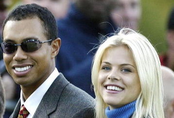 SUTTON COLDFIELD - SEPTEMBER 26:  Golfer Tiger Woods poses with girlfriend Elin Nordegren during the opening Ceremony for the 34th Ryder Cup on September 26, 2002 in Sutton Coldfield, England. (Photo by Andrew Redington/Getty Images)