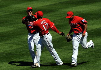 ARLINGTON, TX - APRIL 06:  Josh Hamilton #32, Nelson Cruz #17 and Marlon Byrd #22 of the Texas Rangers celebrate inbetween innings against the Cleveland Indians during the home opener on April 6, 2009 at Rangers Ballpark in Arlington, Texas.  (Photo by Ronald Martinez/Getty Images)