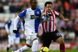 SUNDERLAND, UNITED KINGDOM - JANUARY 24:  Benni McCarthy of Blackburn battles with Andy Reid of Sunderland during the the FA Cup Sponsored by E.on fourth round match between Sunderland and Blackburn Rovers at The Stadium of Light on January 24, 2009 in Sunderland, England.  (Photo by Laurence Griffiths/Getty Images)