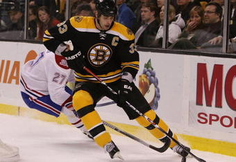BOSTON - JANUARY 13:  Zdeno Chara #33 of the Boston Bruins tries to keep the puck from Alex Kovalev#27 of the Montreal Canadiens on January 13, 2009 at the TD Banknorth Garden in Boston, Massachusetts.  (Photo by Elsa/Getty Images)