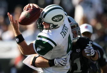 OAKLAND, CA - OCTOBER 19:  Brett Favre #4 of the New York Jets is sacked by Trevor Scott #91 of the Oakland Raiders during an NFL game on October 19, 2008 at the Oakland-Alameda County Coliseum in Oakland, California.  (Photo by Jed Jacobsohn/Getty Images)