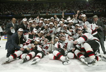 EAST RUTHERFORD, NJ - JUNE 9:  The New Jersey Devils celebrate winning the Stanley Cup after defeating the Mighty Ducks of Anaheim 3-0 in game seven of the 2003 Stanley Cup Finals at Continental Airlines Arena on June 9, 2003 in East Rutherford, New Jersey.  The Devils defeated the Ducks 3-0. (Photo by Elsa/Getty Images/NHLI)