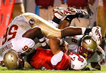 RALEIGH, NC - OCTOBER 16:  Kendrick Stewart #56 and Recardo Wright #48 of the Florida State Seminoles sack quarterback Russell Wilson #16 of the North Carolina State Wolfpack during the game at Carter-Finley Stadium on September 16, 2008 in Raleigh, North Carolina.  (Photo by Kevin C. Cox/Getty Images)