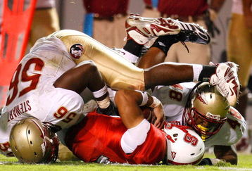 RALEIGH, NC - OCTOBER 16:  Kendrick Stewart #56 and Recardo Wright #48 of the Florida State Seminoles sack quarterback Russell Wilson #16 of the North Carolina State Wolfpack during the game at Carter-Finley Stadium on September 16, 2008 in Raleigh, North Carolina.  (Photo by Kevin C. Cox/Getty Images)