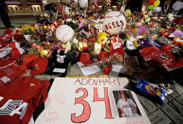 ANAHEIM, CA - APRIL 10:  Fans gather around a makeshift memorial to Los Angeles Angels pitcher Nick Adenhart outside Angel Stadium, after the game against the Boston Red Sox on April 10, 2009 in Anaheim, California. Adenhart and two others were killed in a car crash on Thursday,  April 9.  (Photo by Kevork Djansezian/Getty Images)