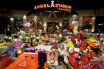 ANAHEIM, CA - APRIL 10:  Fans gather around a makeshift memorial to Los Angeles Angels pitcher Nick Adenhart outside Angel Stadium, after the game against the Boston Red Sox on April 10, 2009 in Anaheim, California. Adenhart and two others were killed in a car crash on Thursday,  April 9.  (Photo by Kevork Djansezian/Getty Images)
