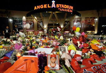 ANAHEIM, CA - APRIL 10:  Fans gather around a makeshift memorial to Los Angeles Angels pitcher Nick Adenhart outside Angel Stadium, after the game against the Boston Red Sox on April 10, 2009 in Anaheim, California. Adenhart and two others were killed in a car crash on Thursday,  April 9.  (Photo by Kevork Djansezian/Getty Images)