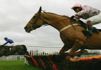 WINDSOR, ENGLAND - DECEMBER 17:  Seamus Durrack and Forager (L) lead the Jimmy McCarthy ridden Darkness over the last flight before landing Division two of The attheraces.com Maiden Hurdle Race run at Windsor Racecourse on December 17, 2004 in Windsor, England. (Photo by Julian Herbert/Getty Images)