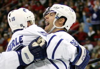 RALEIGH, NC - DECEMBER 18:  Teammate Thomas Kaberle #15 celebrates with Boyd Devereaux #22 of the Toronto Maple Leafs after Devereaux's goal against the Carolina Hurricanes during their game at the RBC Center on December 18, 2007 in Raleigh, North Carolina.  (Photo by Streeter Lecka/Getty Images)