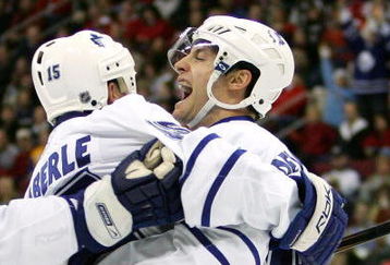 RALEIGH, NC - DECEMBER 18:  Teammate Thomas Kaberle #15 celebrates with Boyd Devereaux #22 of the Toronto Maple Leafs after Devereaux's goal against the Carolina Hurricanes during their game at the RBC Center on December 18, 2007 in Raleigh, North Carolina.  (Photo by Streeter Lecka/Getty Images)