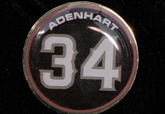 ANAHEIM, CA - APRIL 10:  A memorial pin with jersey number of pitcher Nick Adenhart of the Los Angeles Angels is seen on the jacket of his agent Scott Boras during the baseball game against the Boston Red Sox at Angel Stadium April 10, 2009 in Anaheim, California. Adenhart and two others were killed in car crash on April 9.  (Photo by Kevork Djansezian/Getty Images)