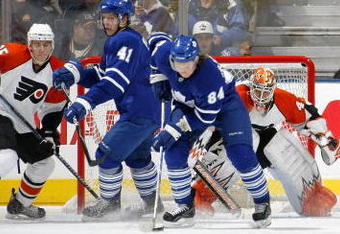 TORONTO - NOVEMBER 29:   Mikhail Grabovski  #84 of the Toronto Maple Leafs carries the puck as teammate Nikolai Kulemin #41 battles in front of Martin Biron #43 of the Philadelphia Flyers along with Matt Carle #25 and Jonathon Kalinski #46 both of the Philadelphia Flyers during their NHL game at the Air Canada Centre November 29, 2008 in Toronto, Ontario.(Photo By Dave Sandford/Getty Images)