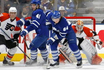 TORONTO - NOVEMBER 29:   Mikhail Grabovski  #84 of the Toronto Maple Leafs carries the puck as teammate Nikolai Kulemin #41 battles in front of Martin Biron #43 of the Philadelphia Flyers along with Matt Carle #25 and Jonathon Kalinski #46 both of the Philadelphia Flyers during their NHL game at the Air Canada Centre November 29, 2008 in Toronto, Ontario.(Photo By Dave Sandford/Getty Images)