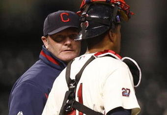CLEVELAND - APRIL 10:  Manager Eric Wedge #22 of the Cleveland Indians talks to Victor Martinez on the mound during the seventh inning of their game against the Toronto Blue Jays April 10, 2009 at Progressive Field in Cleveland, Ohio.  (Photo by Matt Sullivan/Getty Images)