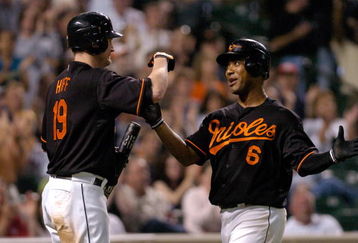 BALTIMORE- JUNE 15:  Melvin Mora #9 of the Baltimore Orioles is congratulated by Aubrey Huff #19 after scoring against the Arizona Diamondbacks at Camden Yards June 15, 2007 in Baltimore, Maryland.   (Photo by Greg Fiume/Getty Images)